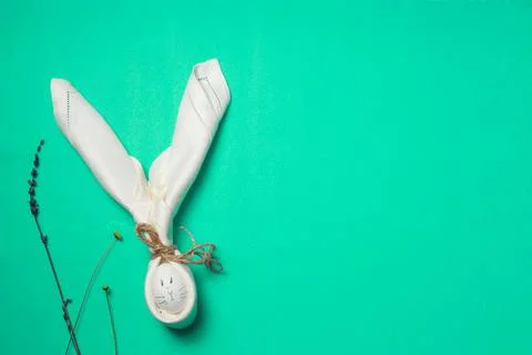 Easter concept, a white egg with a muzzle and rabbit ears made of napkin. On a Stock Photos