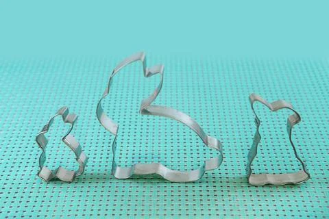 Easter cookie cutters in the shape of bunny on blue background, Foto stock