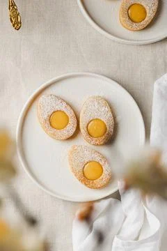 Easter cookies in the form of Easter egg with powdered sugar and lemon cream  Stock Photos