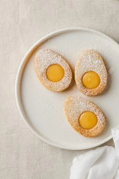 Easter cookies in the form of Easter egg with powdered sugar and lemon cream  Stock Photos