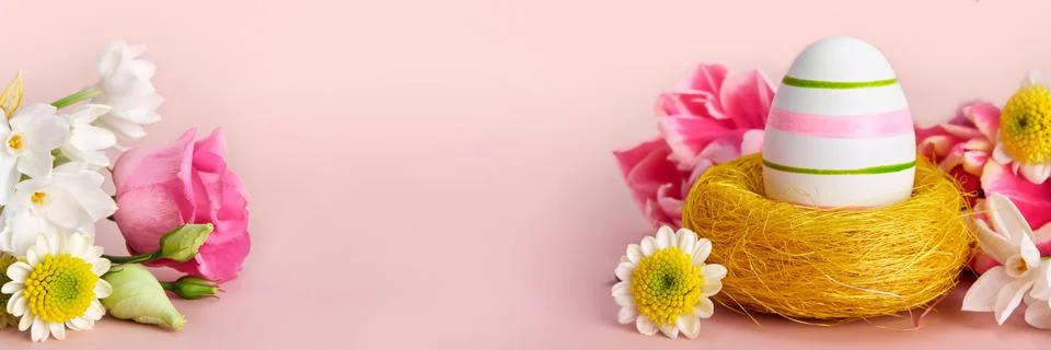 Easter creative composition. Spring flowers, Easter egg and butterflies on pink Stock Photos