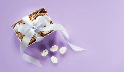 Easter creative layout with Easter eggs in a gift box with lavender blush Stock Photos