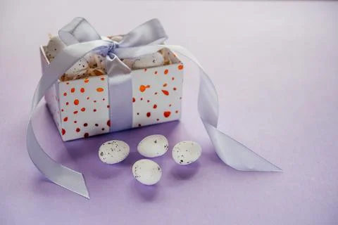 Easter creative layout with Easter eggs in a gift box with lavender blush Stock Photos