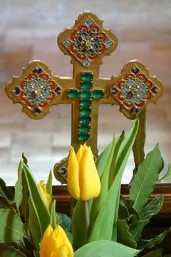 Easter cross with spring flowers Stock Photos