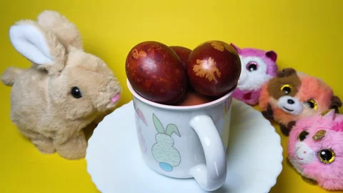 Easter Cup Turntable Spin Surrounded by Cute Fluffy Toys Stock Footage 307677408