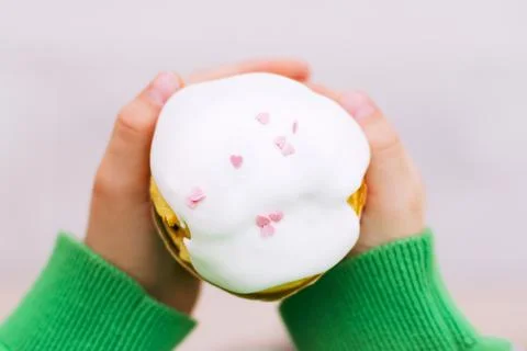 Easter cupcake in the hands of a child Stock Photos