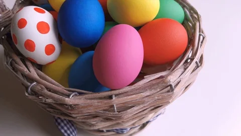 Easter Day, Basket with colorful Easter Eggs on white table Stock Footage 127634106