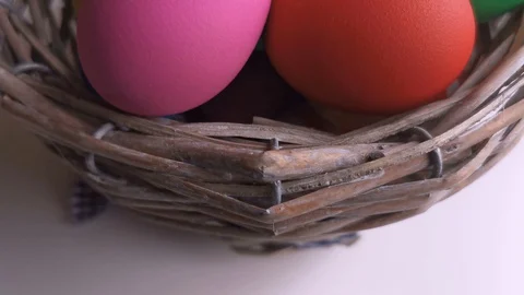 Easter Day, Basket with colorful Easter Eggs on white table Stock Footage 127634196