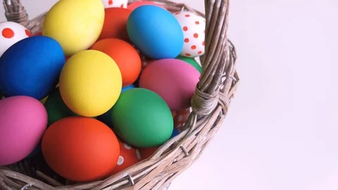 Easter Day, Basket with colorful Easter Eggs on white table Stock Footage 127634217