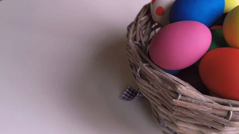 Easter Day, Basket with colorful Easter Eggs on white table Stock Footage 127634257