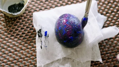 The Easter day. Close-up of women's hands painting hard-boiled chicken eggs. 4K Stock Footage 124253784