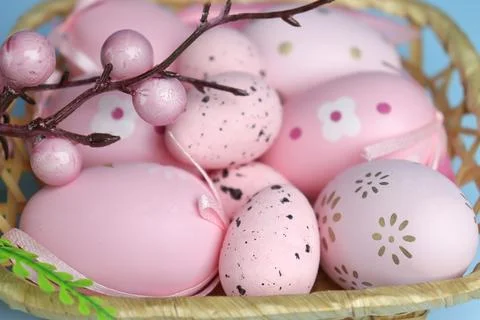Easter decor. A branch with decorations on a blue monochromatic background Stock Photos