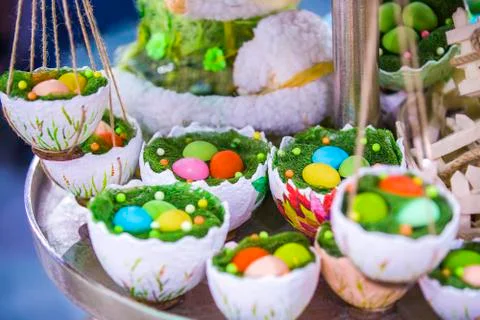 Easter decor, hanging baskets with color eggs in the grass, eggshell baskets, Stock Photos