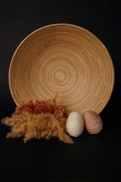 Easter decor. knitted decor eggs and pampas on bamboo plate Stock Photos