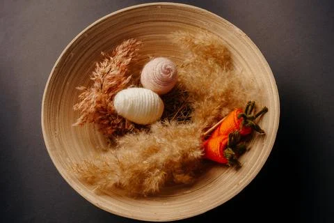 Easter decor. knitted decor eggs, carrots and pampas on bamboo plate Stock Photos
