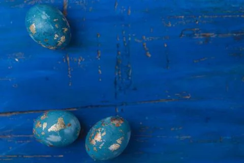 Easter decor, three eggs on a dark blue background. Stock Photos