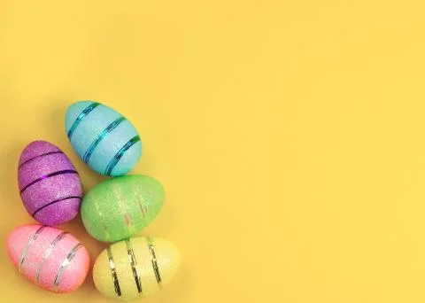 Easter decorated eggs on yellow background. Minimal easter concept. Stock Photos