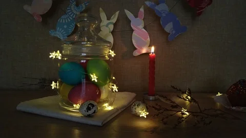 Easter decoration burning candles eggs garlands Stock Footage 104976993