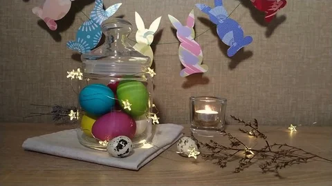 Easter decoration burning candles falling feather Stock Footage 104977593