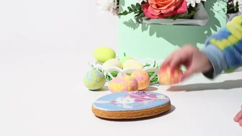 Easter decoration, close-up hand of child putting color eggs into basket on Stock Footage 235944624
