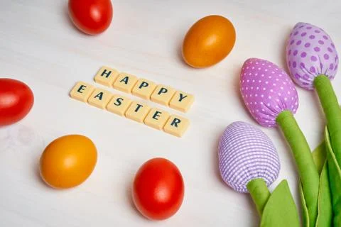 Easter decoration with colored eggs, text and tulips Stock Photos