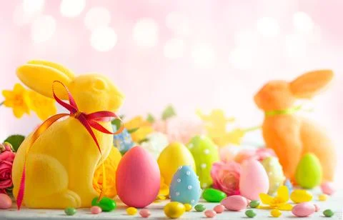 Easter decoration with Easter eggs, colorful rabbits and spring flowers on .. Stock Photos