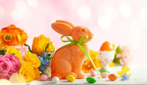Easter decoration with Easter eggs, colorful rabbits and spring flowers on .. Stock Photos