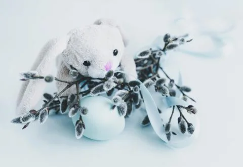 Easter decoration of fluffy Easter bunny and pussy willow with an egg and a blue Stock Photos