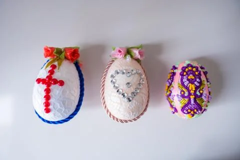 Easter decoration handmade Easter eggs with flowers, cross, heart and beads Stock Photos