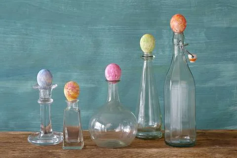 Easter decoration with multicolored easter eggs and vintage glass bottles, Stock Photos