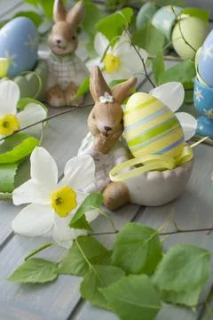 Easter decoration with rabbit, spring flowers and eggs Stock Photos