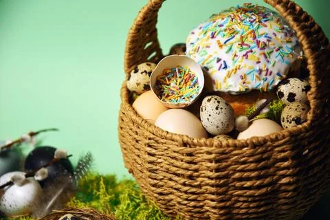 Easter decorations in a basket with rabbit ears. Easter cake and eggs on mo.. Stock Photos