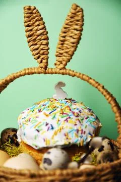 Easter decorations in a basket with rabbit ears. Easter cake and eggs on mo.. Stock Photos