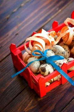 Easter decorations. quail eggs with bow in box Stock Photos