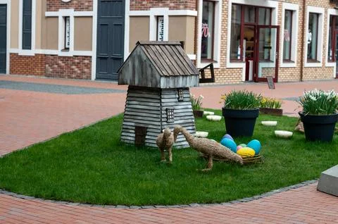 Easter decorations in a town square with straw birds and eggs Stock Photos