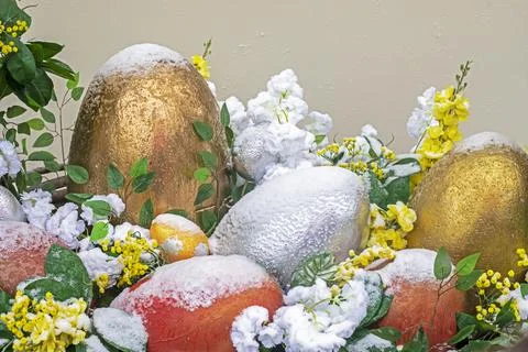 Easter decorative eggs on a light background in the snow. Easter holiday Stock Photos