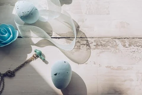 Easter decorative eggs with small enameled bird on chain flower and organza r Stock Photos