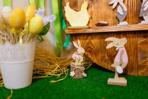 Easter decorative elements, painted eggs, wooden hen, bunny and chicken toys Stock Photos