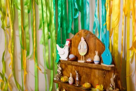 Easter decorative elements, painted eggs, wooden hen, bunny and chicken toys Stock Photos