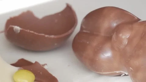 Easter Delight: Chocolate Egg Broken Open for a Sweet Holiday Celebration Stock Footage 332944329