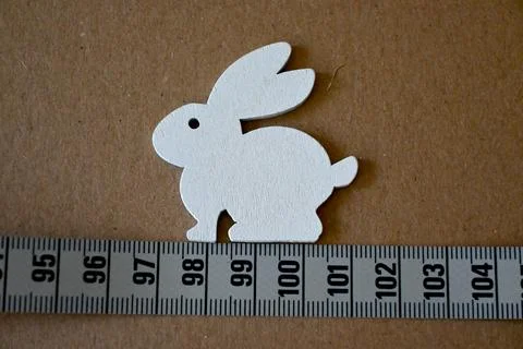 Easter diet concept with rabbit cutout and measuring tape Stock Photos