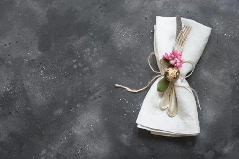 Easter dinner. Elegance table setting pink flowers on dark. Top view. Stock Photos
