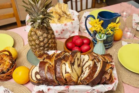 Easter dinner table arranged with pineapple fruit and cozonac sweet bread Foto stock