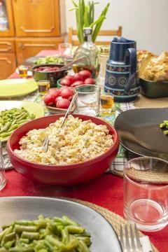 Easter dinner table arranged with red eggs and boeuf salad in the foregroun.. Fotos Stock
