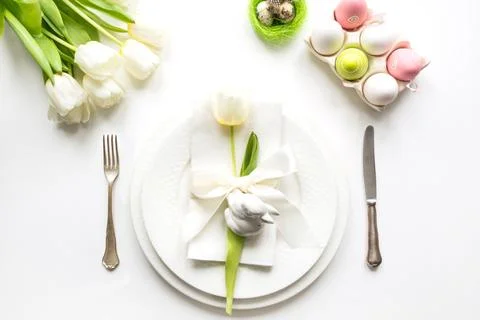 Easter dinner. Table setting with white tulip on table. Top view. Stock Photos
