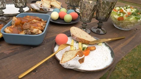 Easter dishes on a table in backyard Stock Footage 122540047