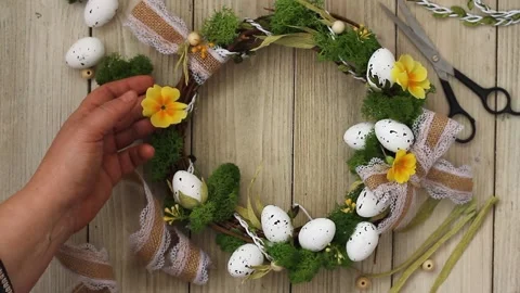 Easter diy wreath with lace bow,stabilized moss,primrose flowers on a gray Stock Footage 172567405