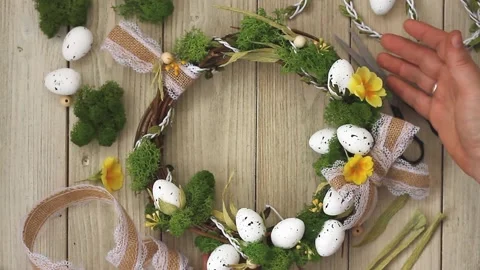 Easter diy wreath with lace bow,stabilized moss,primrose flowers on a gray Stock Footage 172594635