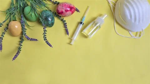 Easter during coronavirus concept. eggs and mask on yellow background. COVID- 스톡 사진