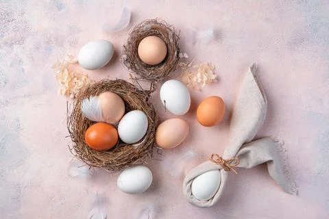 Easter Easter background with eggs in a nest on a light background. Stock Photos